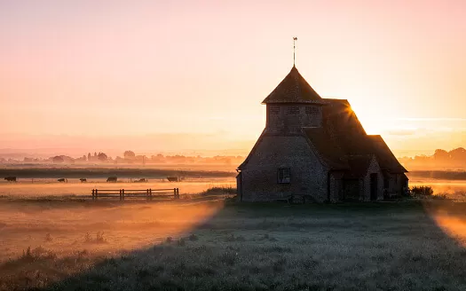 Church on Romney Marsh surrounded by water 